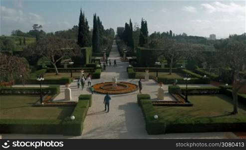 ACRE, ISRAEL- MARCH 12, 2017: Visitors wandering in Bahai garden and enjoying the beauty of its landscape design. World Heritage List in July 2008