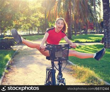 Acrobatic girl riding e-bike in a city park with red t-shirt foldable ebike