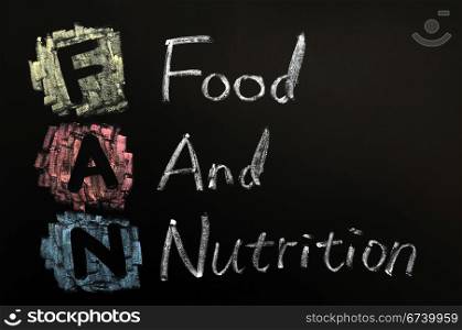 Acronym of FAN - Food and nutrition written in chalk on a blackboard