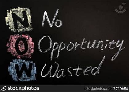 Acronym of NOW - No Opportunity Wasted written on a blackboard