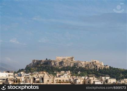 Acropolis hill with the city of Athens surrounding it. Acropolis hill rises above Athens apartments