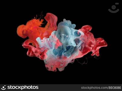 Acrylic colors in water. Ink blot. Abstract background. Isolated on black.