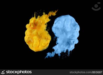 Acrylic colors in water. Ink blot. Abstract black background.