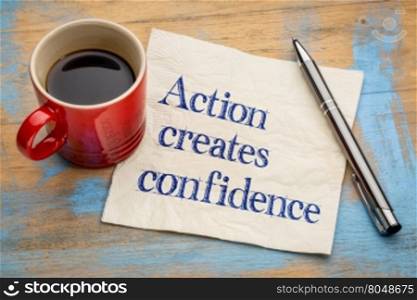 Action created confidence motivational reminder - handwriting on a napkin with a cup of espresso coffee
