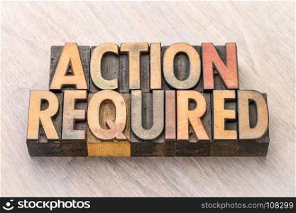 Action required - word abstract in vintage letterpress wood type