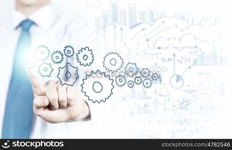 Activate working mechanism. Close up of businessman touching gears mechanism with finger