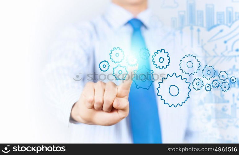 Activate working mechanism. Close up of businessman touching gears mechanism with finger