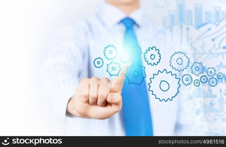 Activate working mechanism. Close up of businessman touching gears mechanism with finger