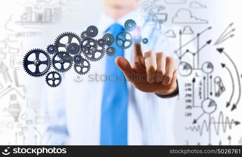 Activate working mechanism. Close up of businessman touching gears mechanism with finger