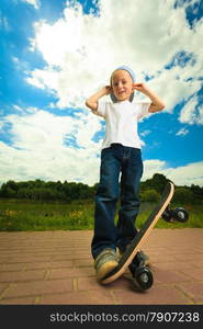 Active childhood. Little man skateboarding. Skater boy child kid with his skateboard. Outdoor.