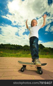 Active childhood. Little man skateboarding. Skater boy child kid with his skateboard. Outdoor.