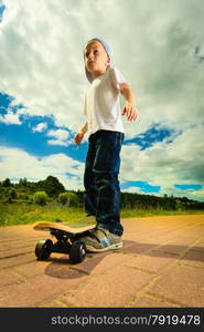 Active childhood. Little man skateboarding. Skater boy child kid with his skateboard. Outdoor.