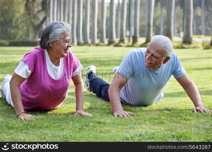 Active elderly couple exercising in park