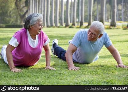 Active elderly couple exercising in park