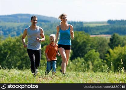 Active Family jogging outdoors in beautiful summer landscape