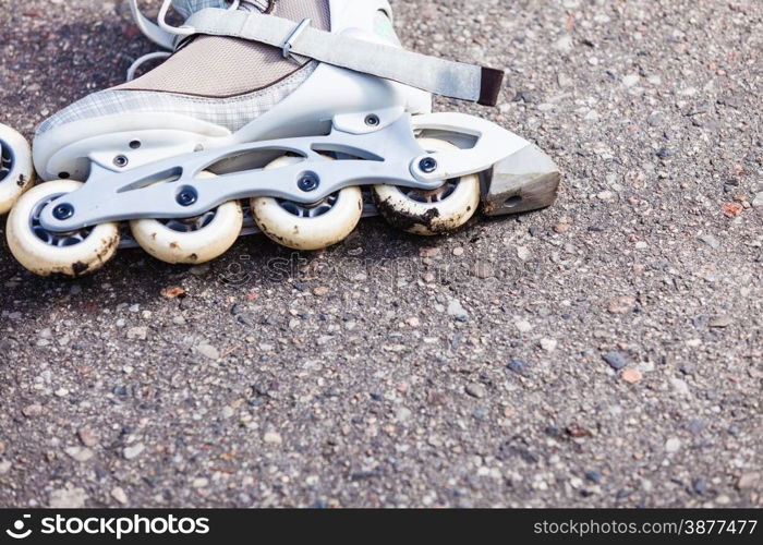 Active fun leisure in spring summer outdoor activities concept. Closeup roller skates on asphalt.