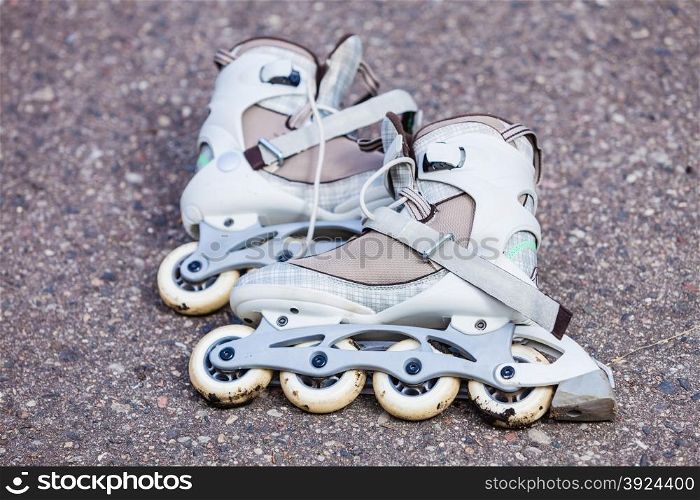Active fun leisure in spring summer outdoor activities concept. Closeup roller skates on asphalt.