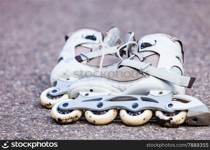 Active fun leisure in spring summer outdoor activities concept. Closeup roller skates on asphalt.