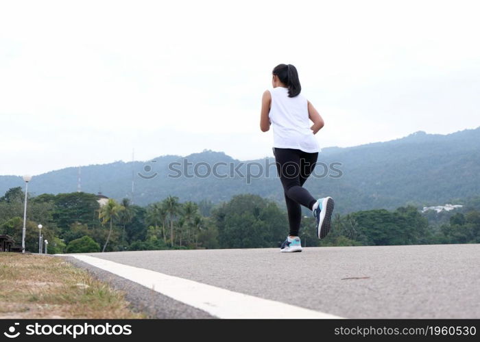 Active healthy woman tying running shoes, jogging runner healthcare and well being concept