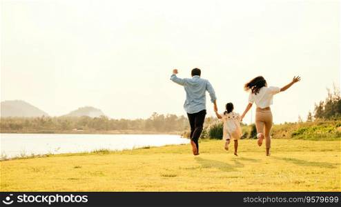 Active lifestyle. a group of family running and having fun in a sunny park, with green grass and blue sky, on a weekend getaway, Happy family day