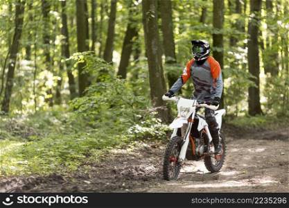 active man riding motorcycle forrest