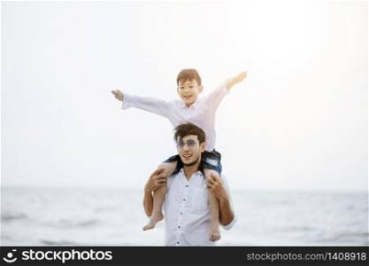 Active parents and people outdoor activity on summer vacations and holiday with children.Happy family and son walk with fun of sunset sea on sand beach.