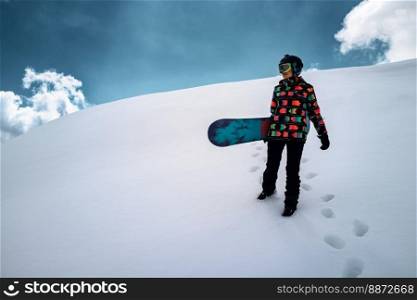 Active people enjoying the snow. Sports life and leisure. Snowboarder tourist girl walking on the mountain top. Ski park resort. Winter holidays and seasonal vacation travel.. Girl snowboarder enjoys winter sport