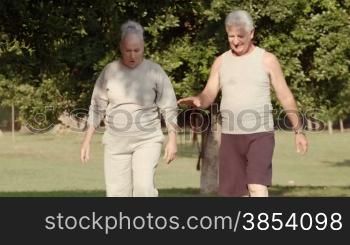 Active retired people, elderly man and woman checking blood pressure in city park after working out and jogging