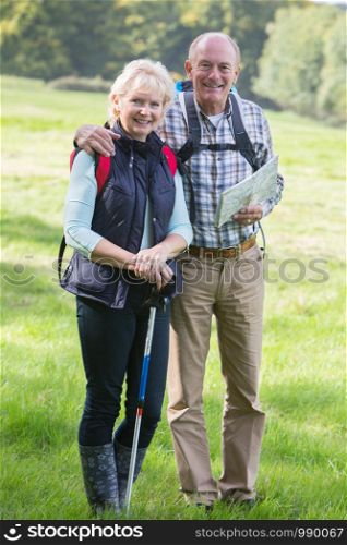 Active Senior Couple On Walk In Countryside Together