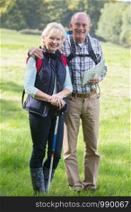 Active Senior Couple On Walk In Countryside Together