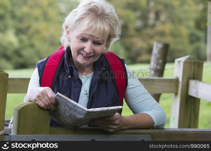 Active Senior Woman On Walk In Countryside