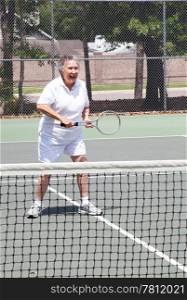 Active senior woman playing a game of tennis.