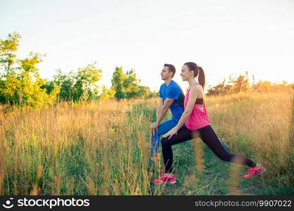 Active sportive couple running in park. Athletic family doing yoga together. Healthy lifestyle fitness concept. Active sportive couple running in park. Health and fitness.