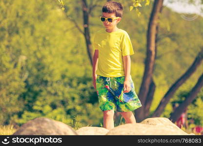 Active time on holidays concept. Young little boy walking running outdoor. Kid child spending time on fresh summer air.. Boy running walking outdoor.