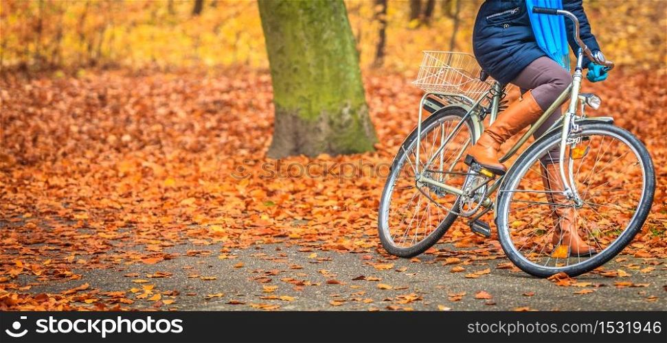 Active woman girl riding bike bicycle relaxing in fall autumn park. Healthy lifestyle and recreation leisure activity.. Active woman riding bike in autumn park.