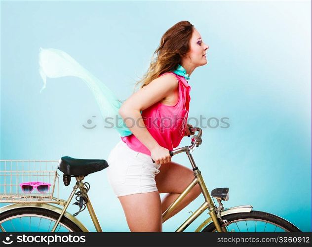 Active woman riding bike bicycle. Hair windblown.. Active woman riding bike bicycle fast against wind. Young girl with hair windblown. Healthy lifestyle and recreation leisure activity. Studio shot.