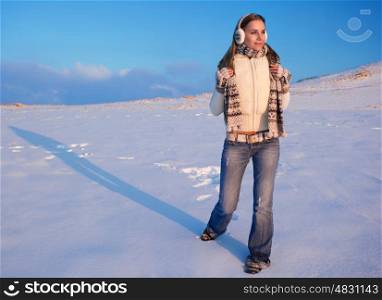 Active woman walking in the mountains covered with beautiful white snow, enjoying amazing winter weather at high altitude