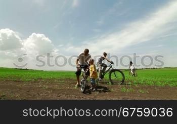 Active young family enjoying bike ride in the country , Wide shot
