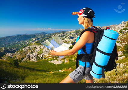 Active young girl searching right track on the map, traveling to high mountains, beautiful landscape, extreme lifestyle, summer vacation