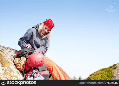Active young woman rock climbing relax with backpack on mountain