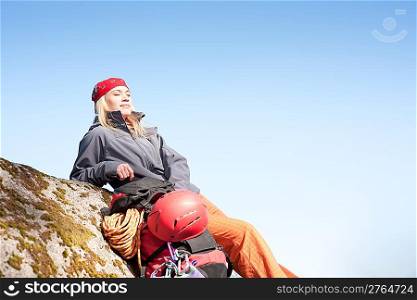 Active young woman rock climbing relax with backpack on mountain