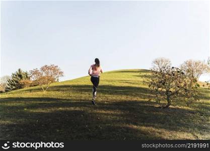 active young woman running park