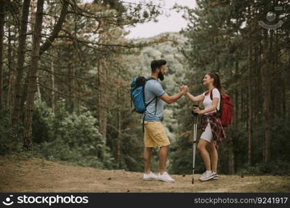 Active youngcouple hikers taking rest in mountain