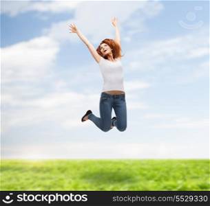 activity and happiness concept - smiling teenage girl in white blank t-shirt jumping