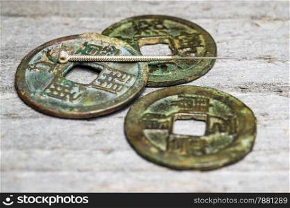 acupuncture needle on chinese antique coins