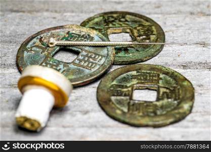 acupuncture needle on chinese antique coins