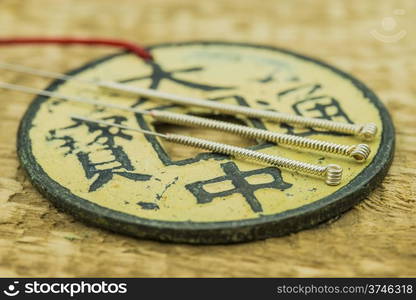 Acupuncture needles with antique chinese coin