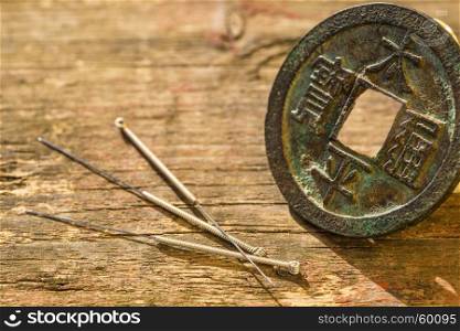 Acupuncture needles with antique chinese coin