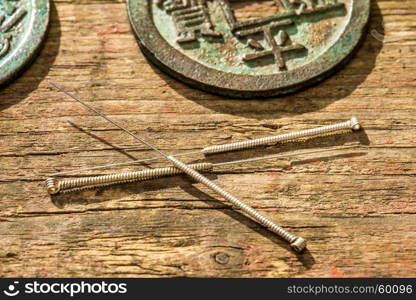 Acupuncture needles with antique chinese coin