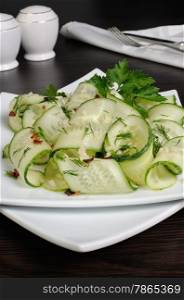 Acute appetizer of fresh cucumbers with garlic, dill, spices